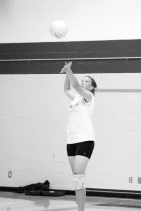 Sophomore Cayla Calderwood serves up to her varsity teammates during volleyball practice last week.