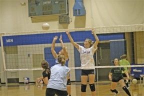 Falcon Katie Holt reaches for the ball Monday as volleyball coach Tim Durbin reviewed the essentials of rotation