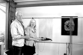 Artists Earl and Natalie Olsen stand at the loom that Earl built for his wife.