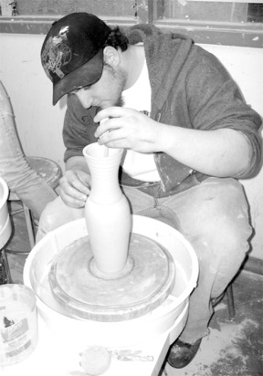 Eric Smits works the pottery wheel in the ceramics studio at Oak Harbor High School. Smits is an entrant in the "Arts and Appetizers" art show at Greenbank Farm today.