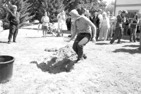 A Bayview School student drops a red paper heart into a hole at a special ceremony Thursday at the school. Bayview students planted a flowering cherry tree during a “Ceremony of Loss” to remember lost loved ones.