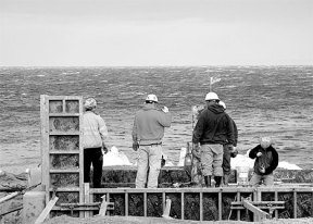 Workers brave 40-plus mile-an-hour winds Thursday as they continue pouring the foundation for a new boat launch ramp at Bush Point. The Port of South Whidbey's other major project is the Clinton Beach renovation and both are slated to be finished by Memorial Day