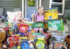 Hailey Robinson sits among the gifts she collected for the dogs at the WAIF Shelter in Coupeville.