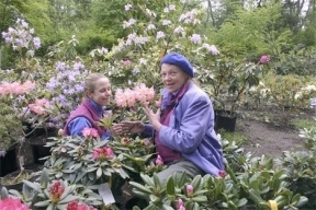 Oriana Simmons-Otness and Kristi O'Donnell take time out to smell the fragrant blooms of "Mary's Favorite