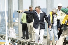 South Whidbey Yacht Club Commodore Derek Pritchard christens the club's new fleet of wooden