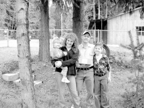 Artie and Jacqueline Pierce with their children Cullen and Arabella gather with the package holding the ashes of Artie’s mother Friday.