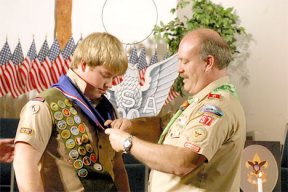 Troop 57 Scoutmaster Ken Berry pins new Eagle Scout Todd Berry with his new rank during a ceremony at Christian Missionary Church in Langley. Just four percent of all Scouts have attained the rank of Eagle since 1911.