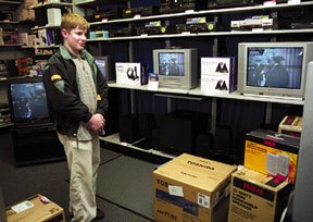 Daniel Hagen of Freeland watches The Patriot at Radio Shack in Freeland. The DirecTV satellite systems the business sells are in direct competition with Whidbey Island cable television franchises