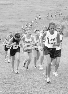 Mary Bakeman and Nancy Godsey suffer one of the big climbs at the Iolani Invitational Saturday in 85-degree weather.