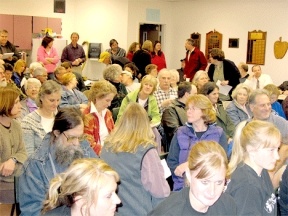 A crowd of 150 people packed the Intermediate School community room to voice objections to the high school’s recent ban of the peace symbol on students T-shirts depicting the names of the more than 2