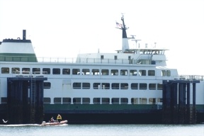 Washington State Ferries personnel motor past a mooring at the Clinton ferry terminal in preparation for a damage inspection of the ferry M/V Catlamet. The ferry was brought to Clinton after it hit the Mukilteo ferry dock Friday morning.