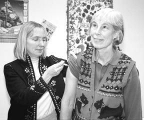 South Whidbey resident Lisa Bjork receives a flu vaccine from Shannon McDonnell at the South Whidbey Health Department yesterday. Bjork was one of about 100 people who poured through clinic doors beginning at 1 p.m. for one of the remaining doses still available. Health department officials divided the remaining doses available between Coupeville