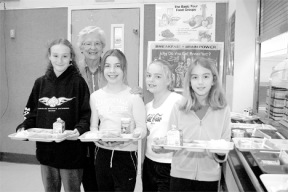 Gene White is surrounded by children at the Intermediate School in Langley. White’s work to feed children all over the world has made her this month’s Hometown Hero. White is joined by students (from left) Maddy Jerome