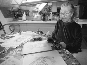 Surrounded by drawings she has done of both real and composite criminals