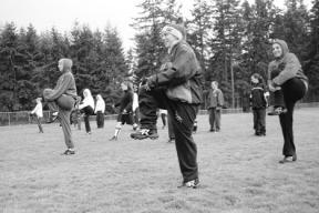 Warming up this week with the varsity fastpitch team are sophomores Carolann Lubach and Christie Robinson