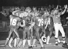 The entire Falcon offensive line turns out to congratulate junior running back Michael Lodell after he scored his fourth touchdown in the first half of Friday night's game against Blaine.