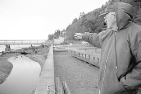 Thor Moen points out a meandering channel and a pile of driftwood he and other fishermen believe are preventing salmon from entering Glendale Creek.