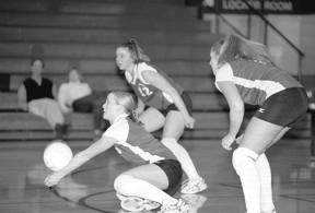 Senior Mary Murphy digs the ball out in the opening game Thursday against Nooksack Valley while fellow seniors Julie Robinson