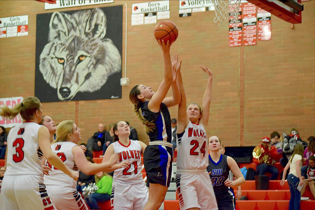 Ari Marshall photo                                South Whidbey senior Kacie Hanson attempts to convert two points against Coupeville on Saturday night. The Falcons earned their first victory of the season with a 43-29 win over the Wolves and improved to 1-2 overall.