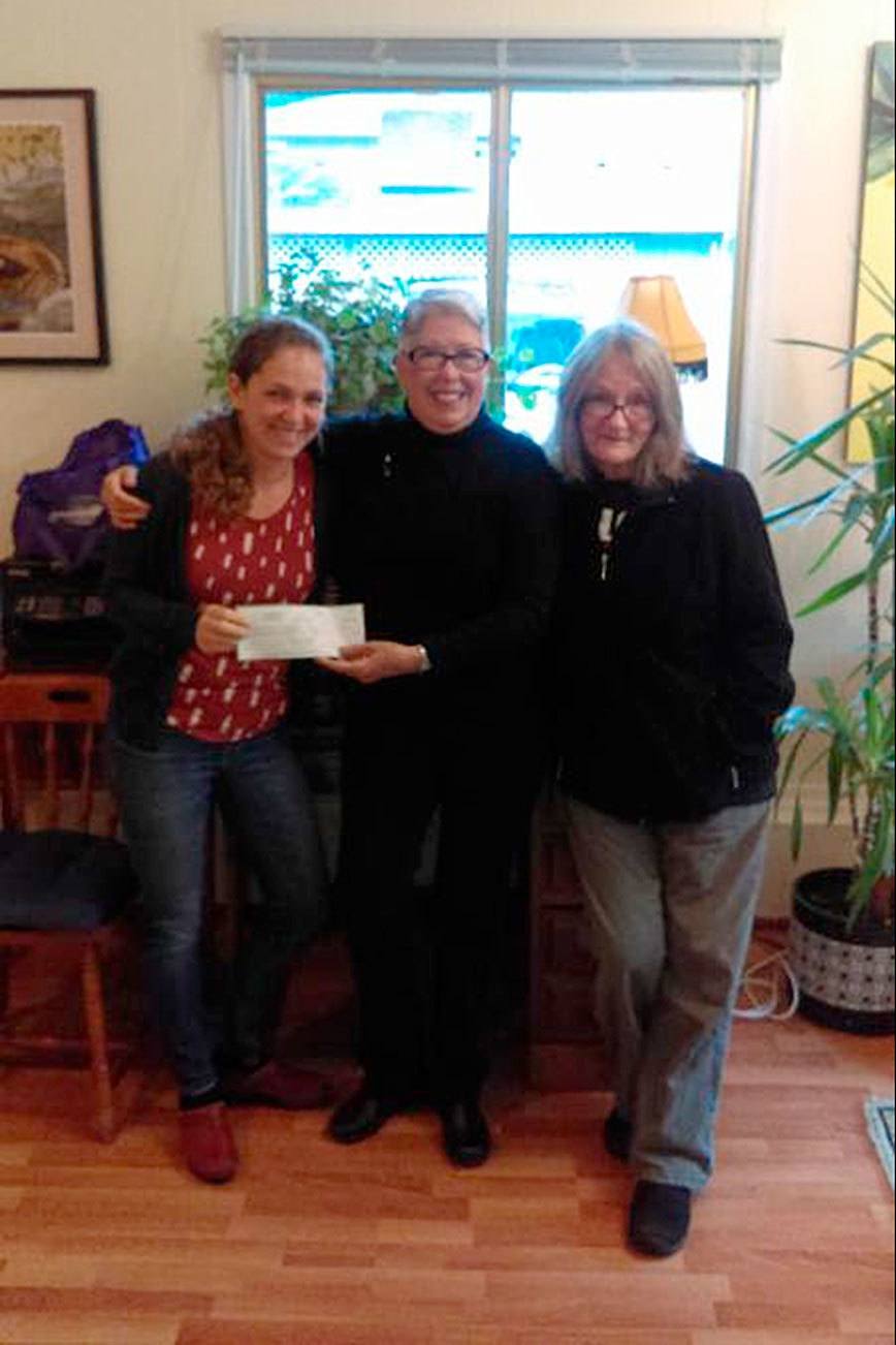 Contributed photo                                Island Athletic Club Vice President Katie Shapiro, left, hands a check to South Whidbey Homeless Coalition’s Faith Wilder, center. Judy Thorslund, a board director, is on the right.