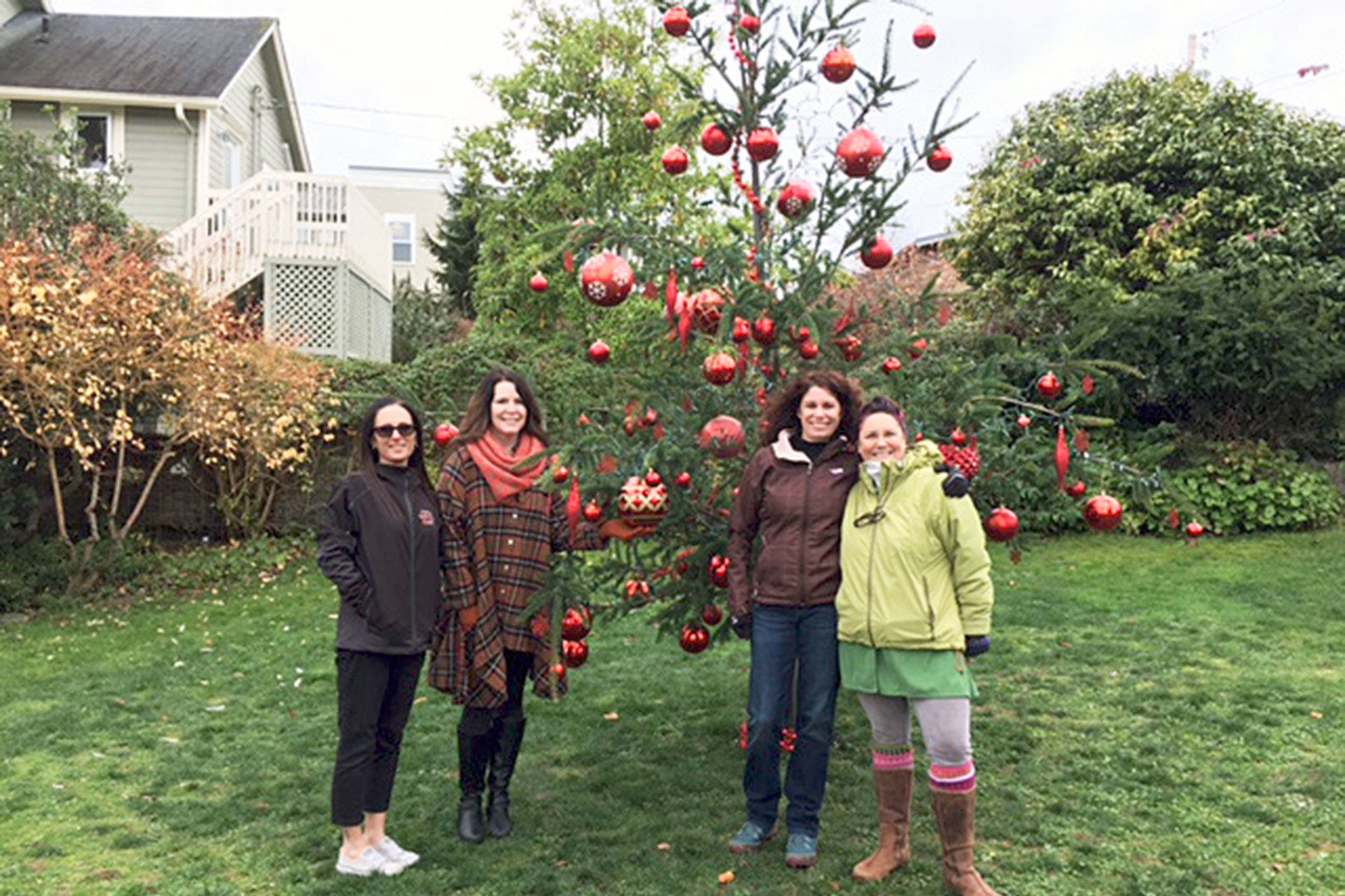 Contributed photo                                Langley Chamber of Commerce representatives Ursula Shoudy, Michaleen McGarry, Robin Black and Lilly van Gerbig stand next to a Douglas fir tree they decorated for the Lighting of Langley event on Nov. 26. The tree was donated by the Whidbey Camano Land Trust.
