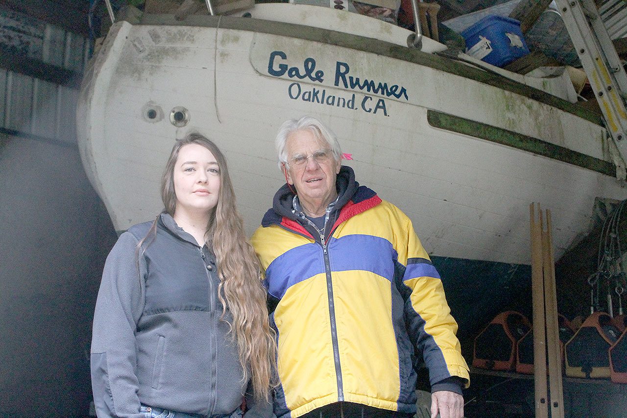 Evan Thompson / The Record                                Erik Rohde’s girlfriend, Nina Planque, and Bill Rowland stand in front of the Gale Runner, a 31-foot dismasted sailboat that is linked to the deaths of three U.S. Coast Guardsmen in 1997.