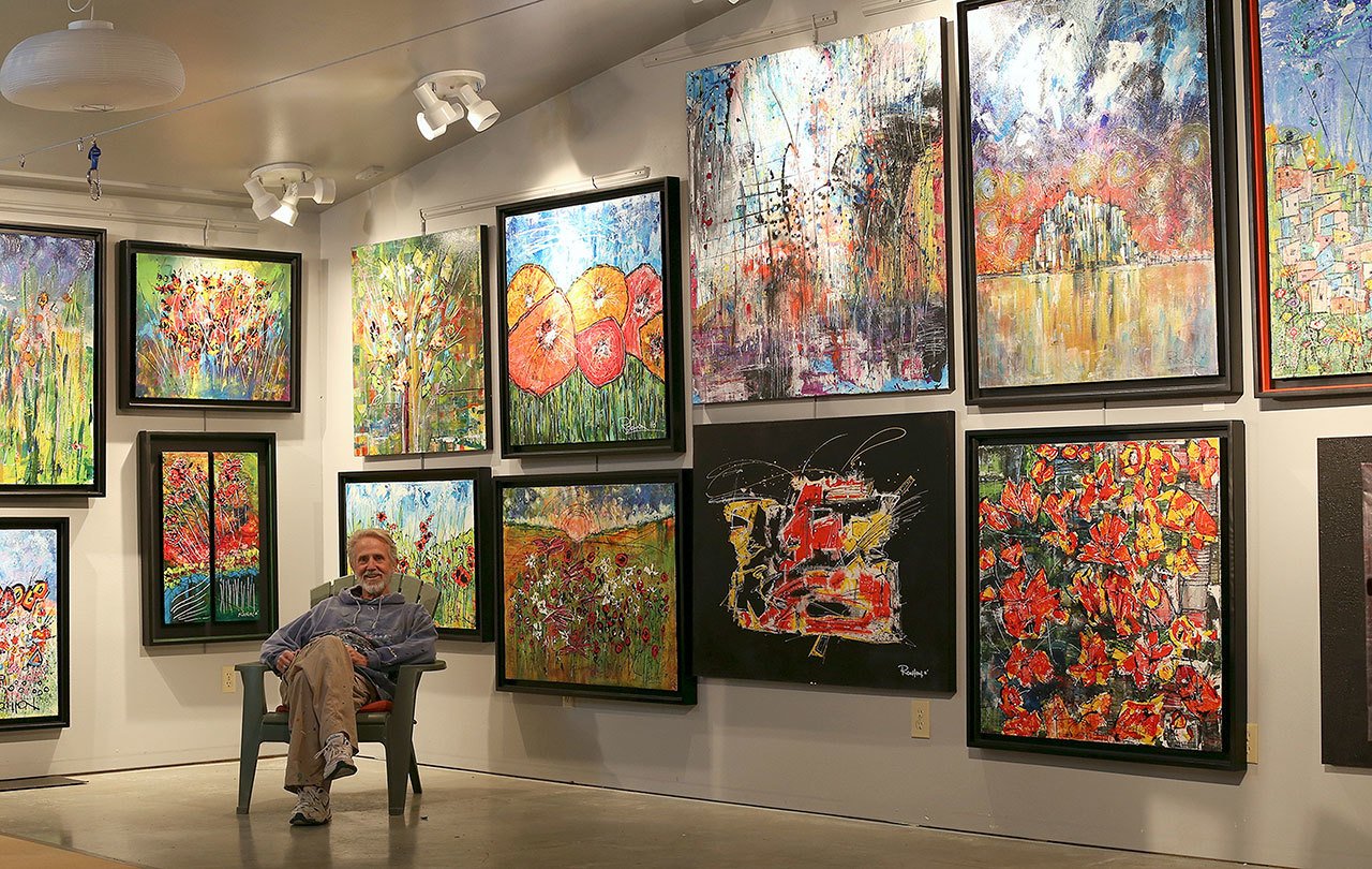Contributed photo                                Louie Rochon sits in his 600 square foot studio space. Rochon’s work illustrates the swing of emotions he typically goes through due to his bi-polar disorder and clinical depression.