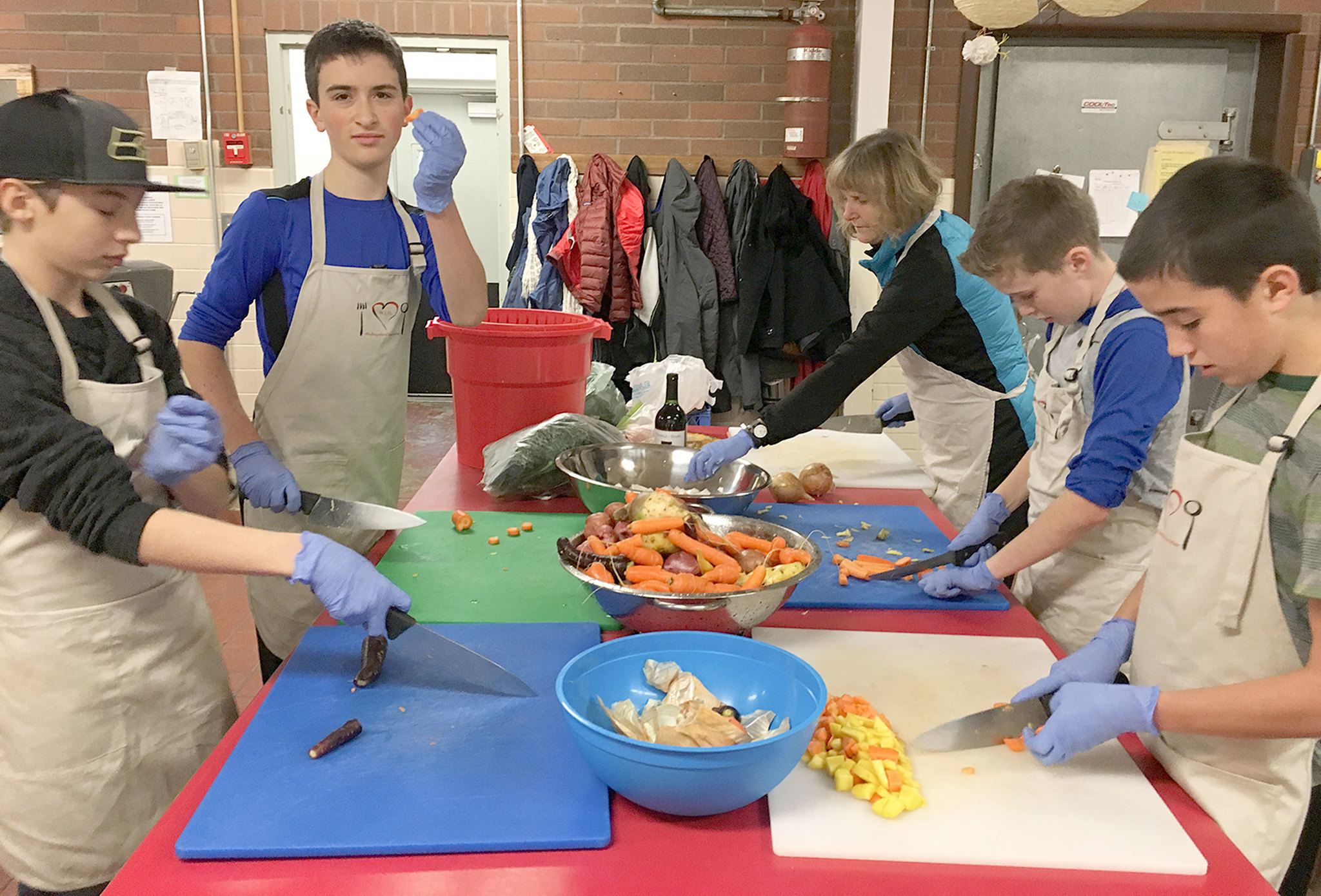 Contributed photo                                A seventh-grade class from Whidbey Island Waldorf School participates in a service project to help Whidbey Island Nourishes make lunches. Whidbey Island Nourishes was the recipient of a grant from The Employees Community Fund of Boeing Puget Sound (ECF).