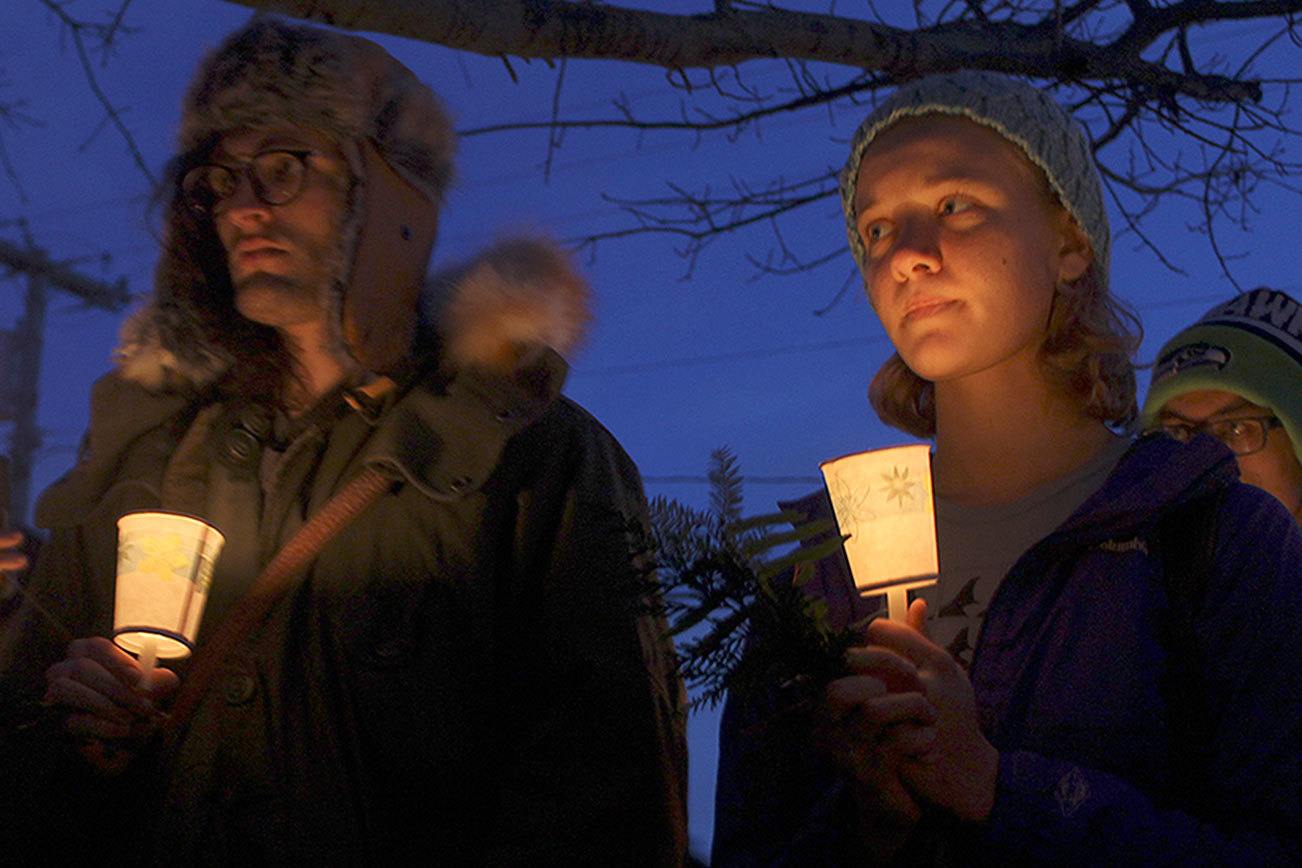 Evan Thompson / The Record                                Jonathan Tollefson (left) and Dinah Hassrick (right) hold a candelight vigils during a memoriam for J34 on Tuesday night at Whale Bell Park in Langley. J34, a Southern Resident Killer Whale, died on Dec. 20.