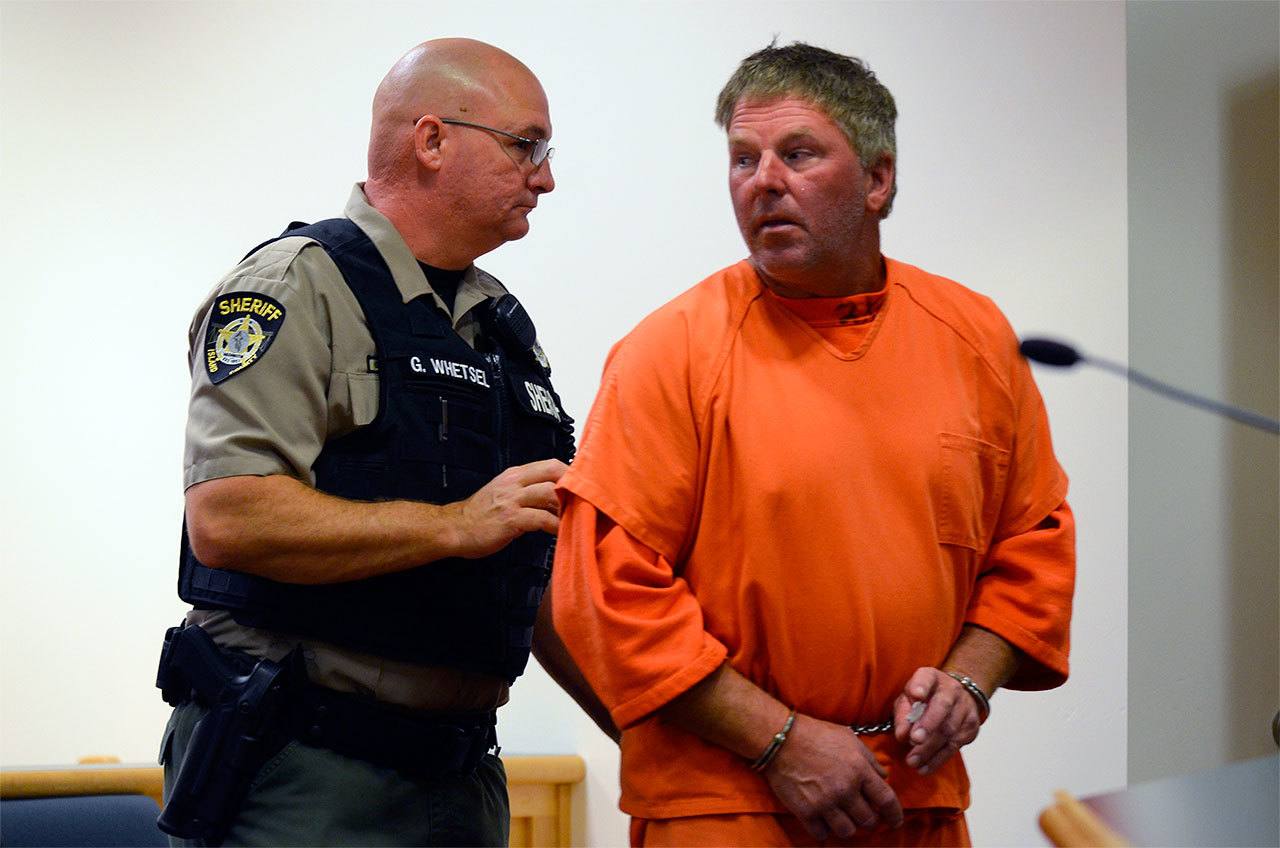 David Hinton, 52, is escorted from an Island County Superior Courtroom in August. He was arrested on suspicion of vehicular homicide.