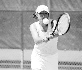 Jenny Saephan guns for the 2A doubles championship at the state tennis meet in May with partner Kylie Bozym. Saephan will return to the Falcon lineup next spring to either defend her championship or to cover new ground as a singles player.