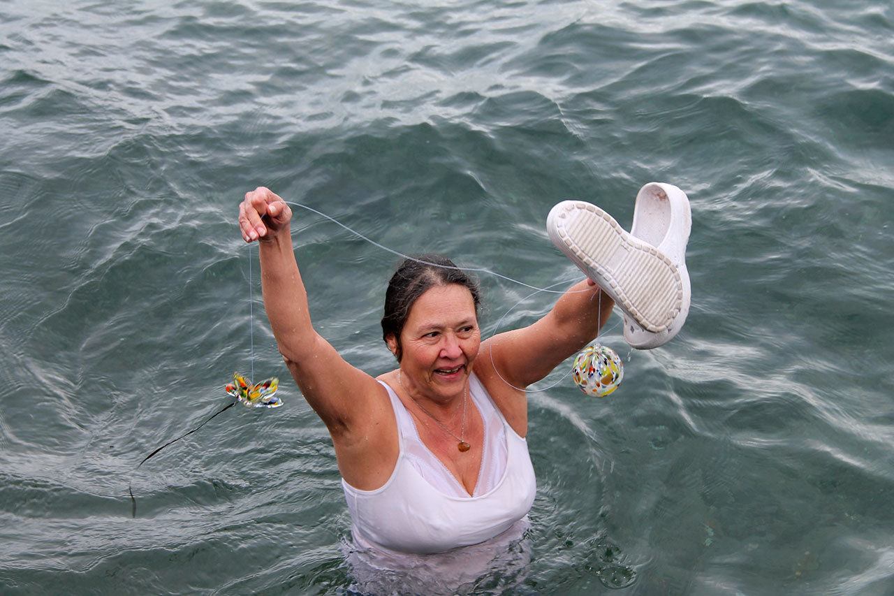 Kyle Jensen / The Record                                Admirals Cove resident Bonnie Nichols was brave enough to bare the chilly waters off Seawall Park. She beat a group of teenagers to the colorful sea float she took home.