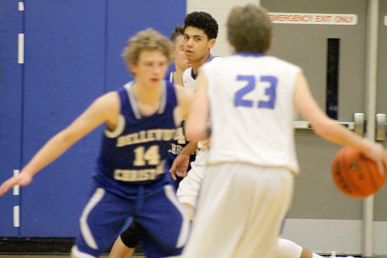 Evan Thompson / The Record                                South Whidbey junior Lewis Pope looks to his teammate Kellen Boyd (23) for a pass against Bellevue Christian on Dec. 3. Pope scored 25 points in a 64-63 win over Cedar Park Christian on Jan. 3.