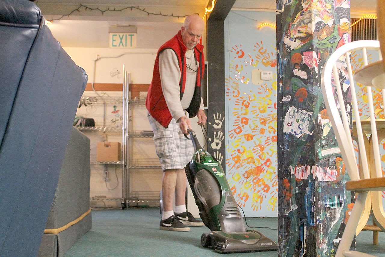 Evan Thompson / The Record —                                Bruce Allen vacuums the floor at The HUB in Langley. The HUB will reopen on Monday, Jan. 23 after a six-month-long hiatus due to insufficient funding.