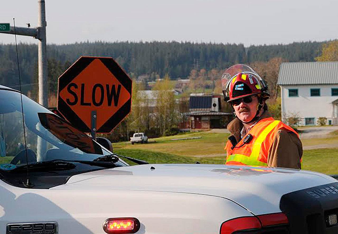 Contributed photo &mdash; Volunteer firefighter and captain Jerry Beck oversees operations during a call.