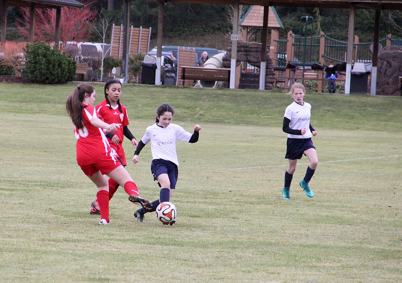 Contributed photo — Nicole Murnane steps in front of an Issaquah FC player to steal a ball. Elizabeth Haines is behind her in support.