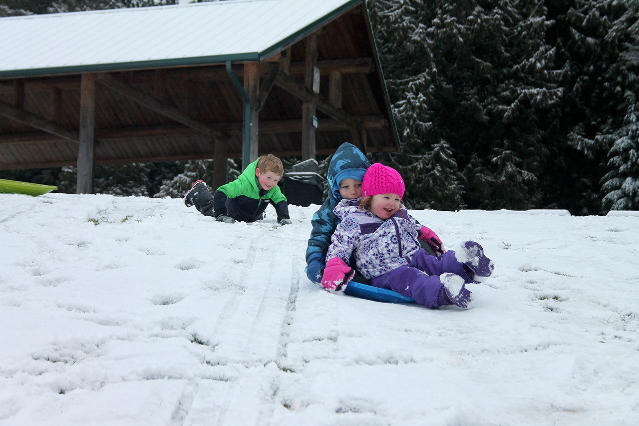 Kyle Jensen / The Record &mdash; Kids grabbed whatever they could from skim boards to trash lids to speed downhill. Left to right: Axton Mozer, 4, Wesley Samuelson, 4, and Summer Mozer, 2.