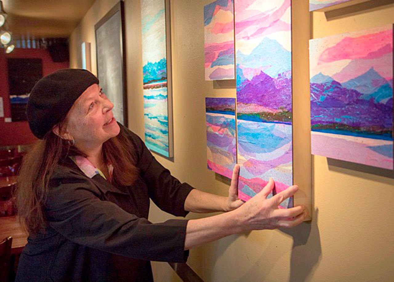 Contributed photo &mdash; Kristi O&rsquo;Donnell sets up her art exhibit &ldquo;I See Beauty For You Today&rdquo; for a past showing at Prima Bistro.