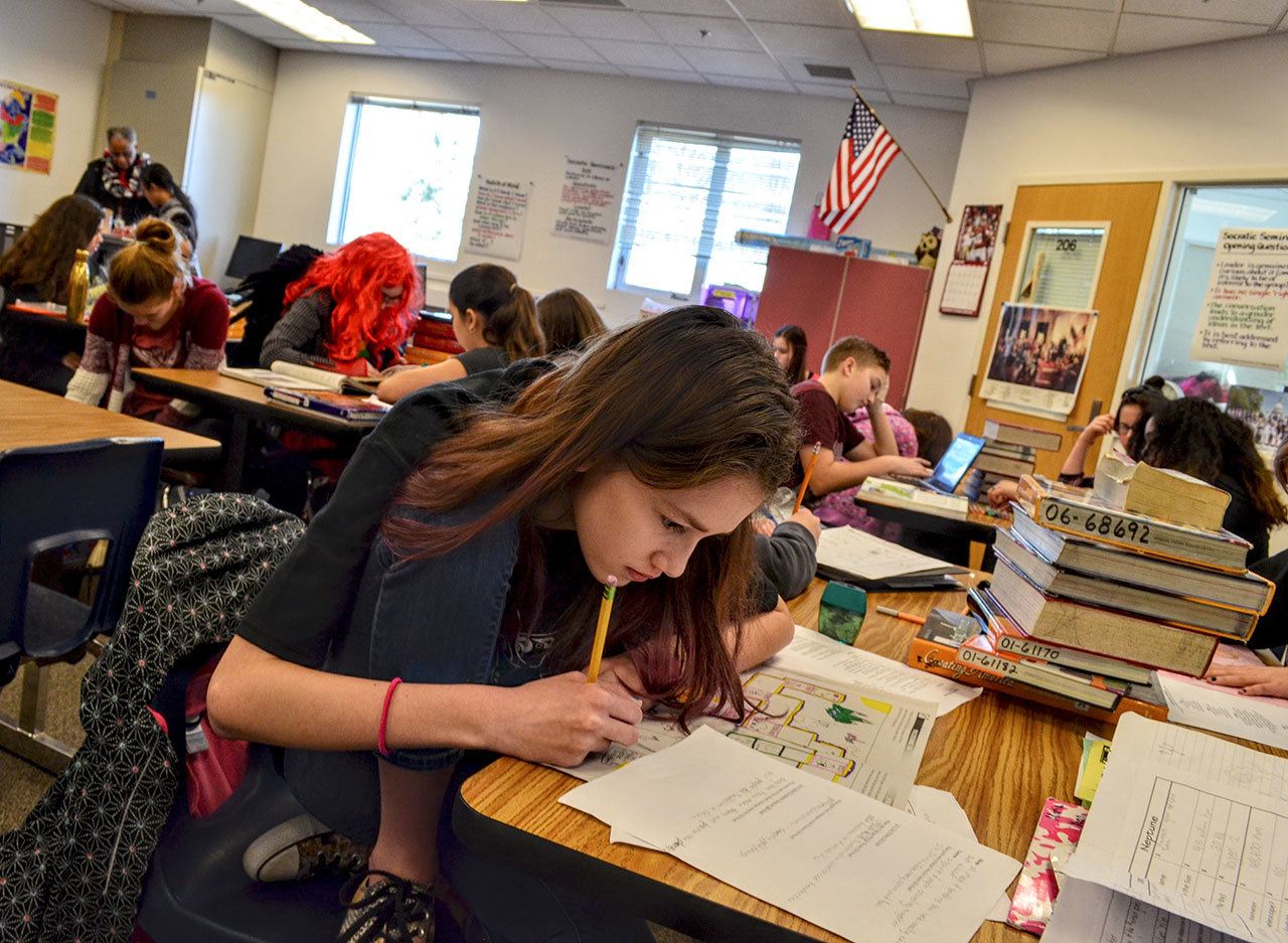 Grace Swanson / WNPA — A student works on her history assignment at Aspire Middle School. North Thurston School District could lose $10 million with the scheduled 4 percent levy drop.