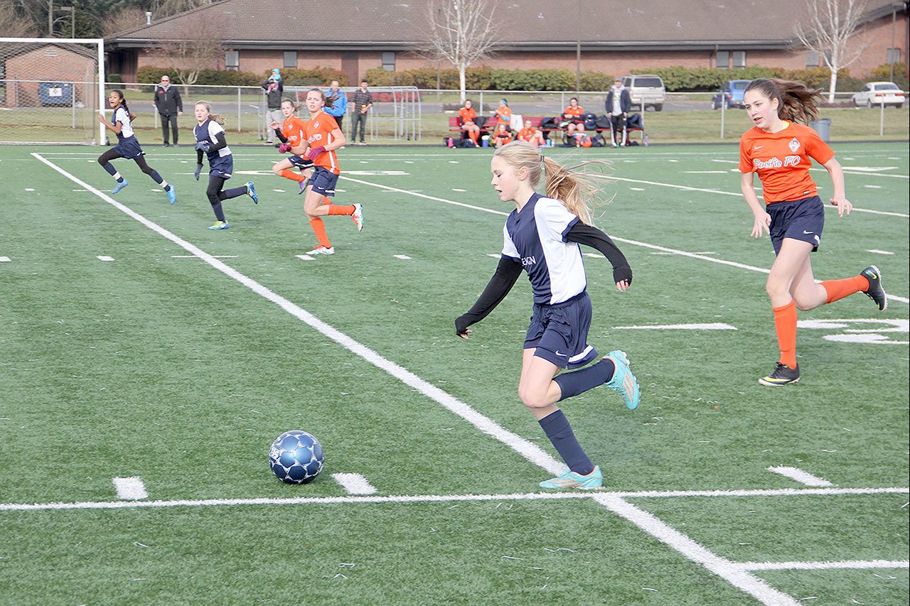 Bob Murnane photo — South Whidbey Reign player Mikenna Wicher leads an attack against Pacific FC Elite Club on Saturday, Jan. 28 in Vancouver, Wash. Wicher’s teammates Adeline McCleary and Leniece Gonzales also move up the field to support Wicher’s attack.