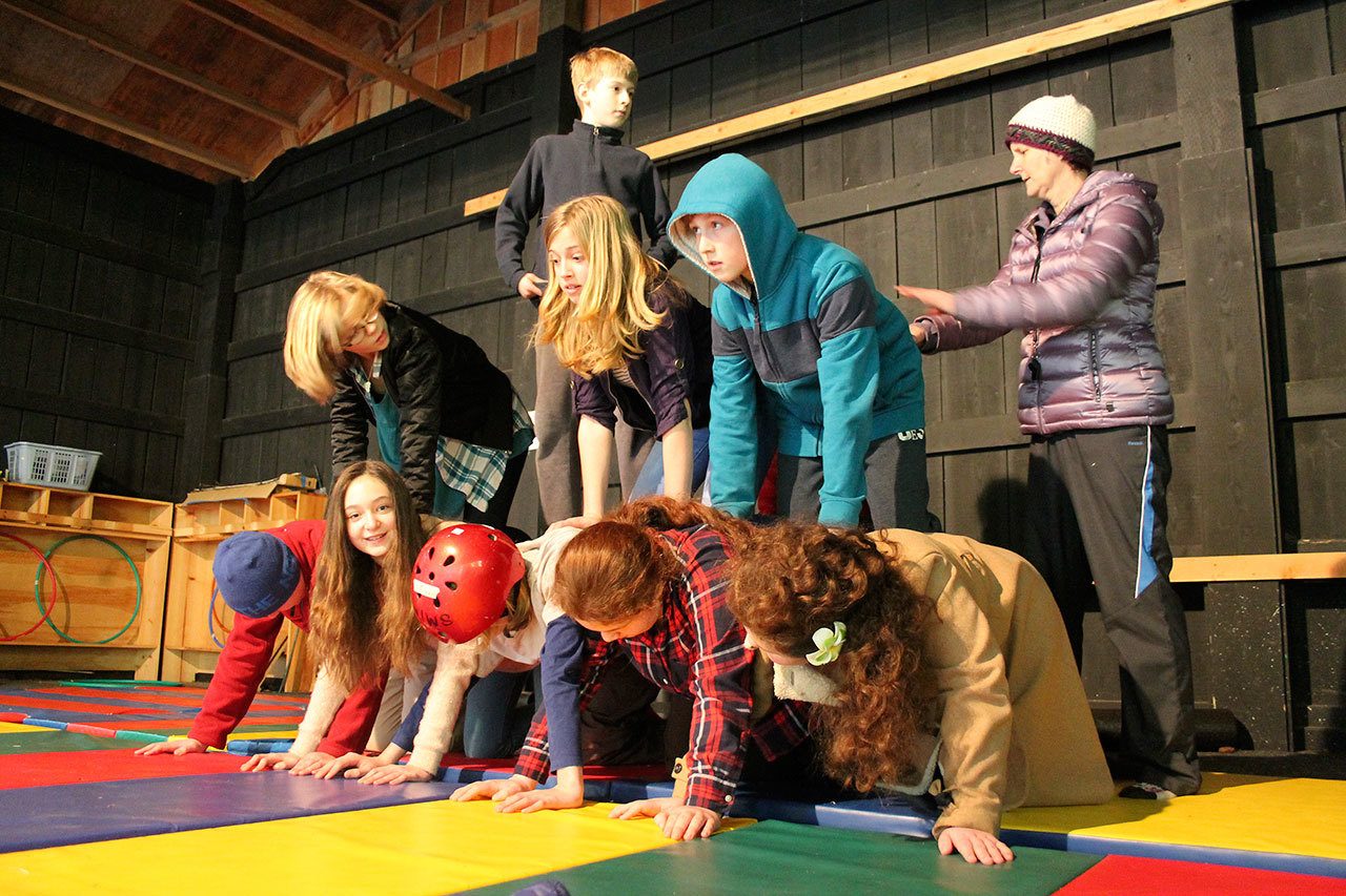 Kyle Jensen / The Record — Whidbey Island Waldorf School’s sixth graders build a human pyramid on Monday afternoon, despite having one classmate missing for the day.