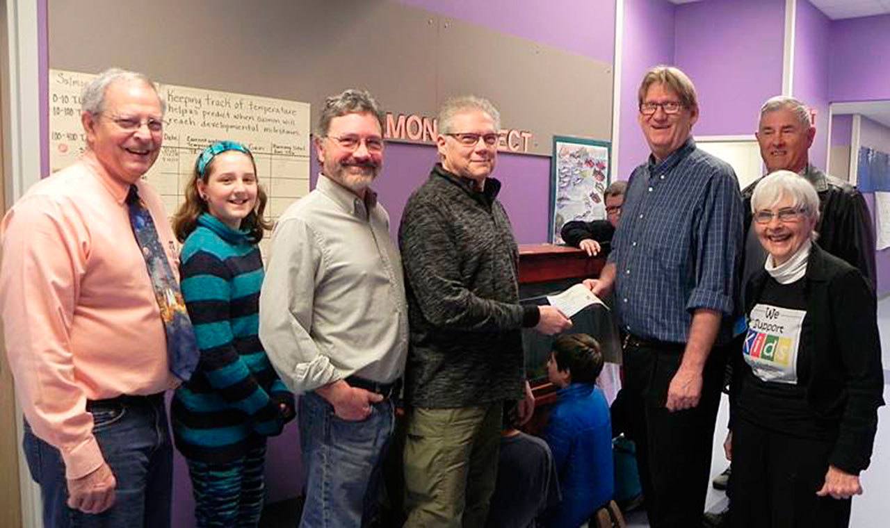 Contributed photo — Steve Mooney of Holmes Harbor Rod & Gun club presents fifth-grade teacher John LaVassar with a $1,200 check to fund the ‘Salmon in the Classroom” project. From left: fifth-grade teacher Bruce Callahan, student classroom salmon ambassador Macie Vandewerfhorst, and SWSF Board members Chris Gibson, Bob Wiley and Jean Shaw.