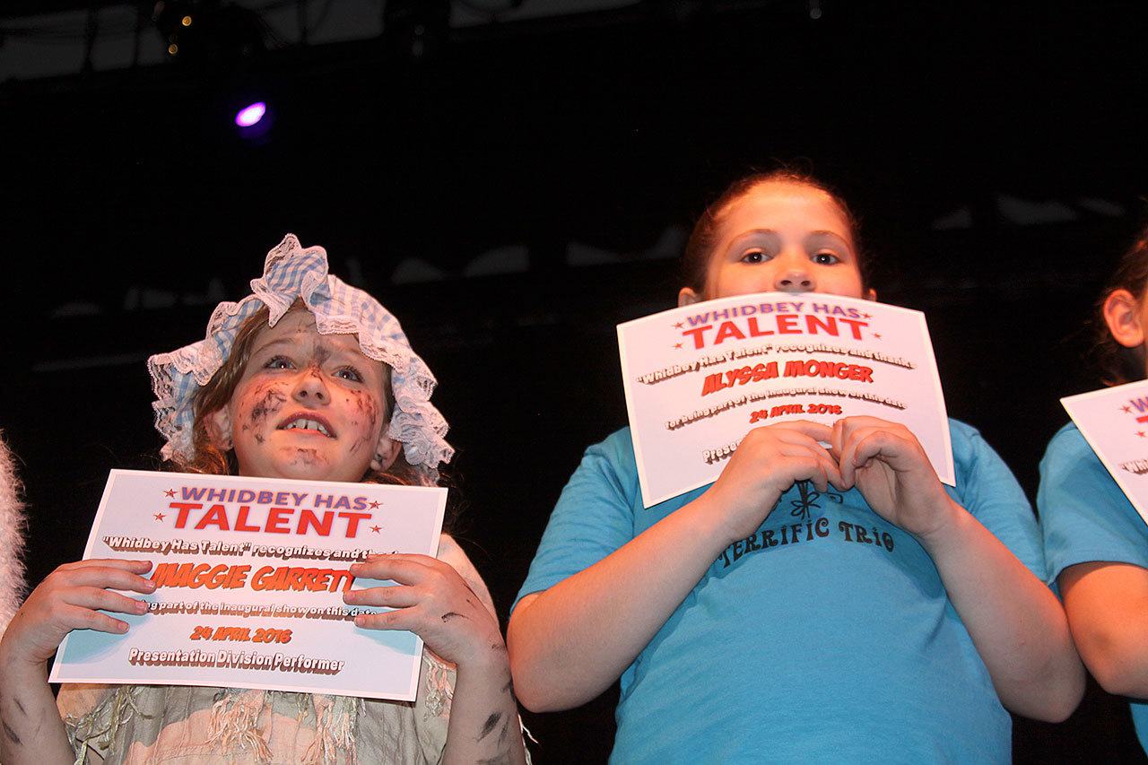 Ron Newberry / Whidbey News Group — Maggie Garrett, left, and Alyssa Monger hold up certificates after participating in the first ‘Whidbey Has Talent’ at Oak Harbor High School last year.