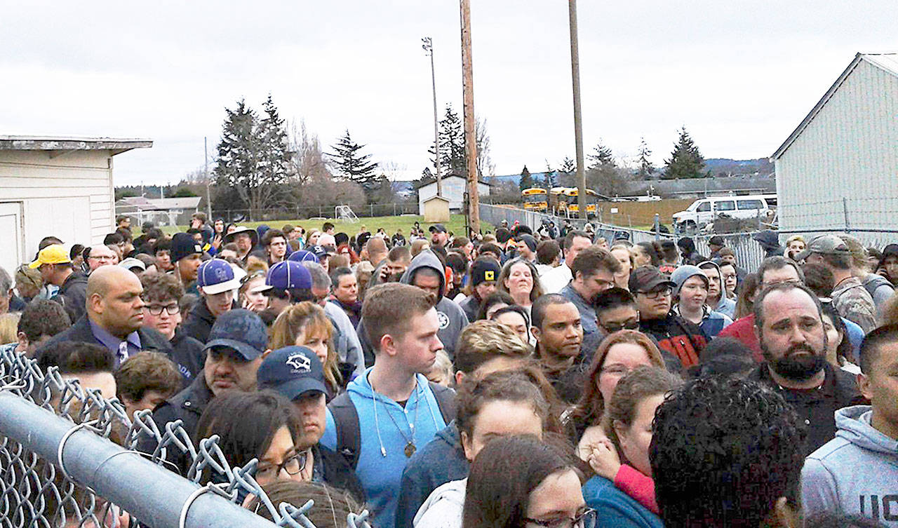Oak Harbor High School students, evacuated to Veteran Stadium Thursday due to a bomb threat, bottleneck as they wait to be picked up by their parents or guardians. Photo by Elaine Reyes Torres.