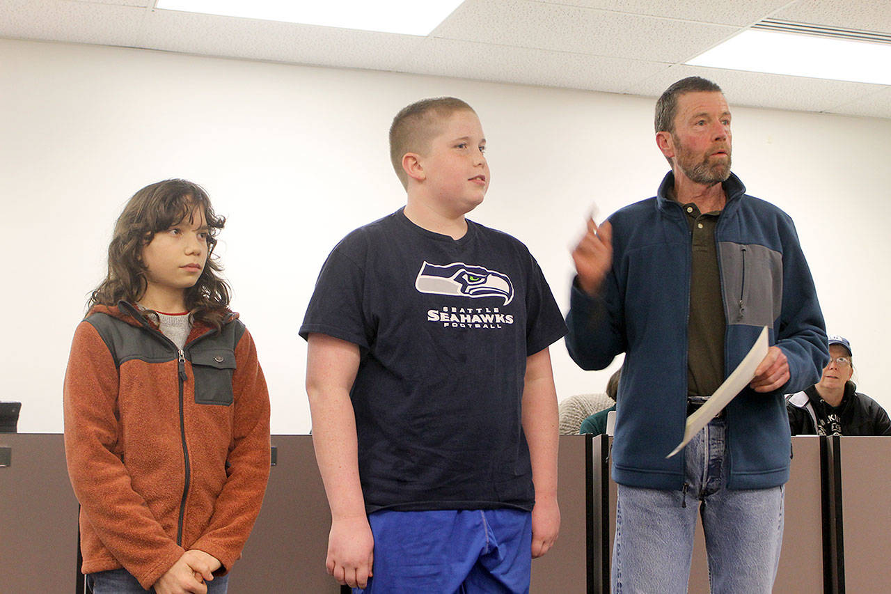 Evan Thompson / The Record — Sol Rabinovich (left) and Joshua Marks (center) were recognized by the South Whidbey School Board for finishing first and second in the Langley Middle School geography bee, respectively. Jack Terhar, a longtime middle school teacher, stands next to the students and described their work ethics. Rabinovich recently qualified for the state geography bee.