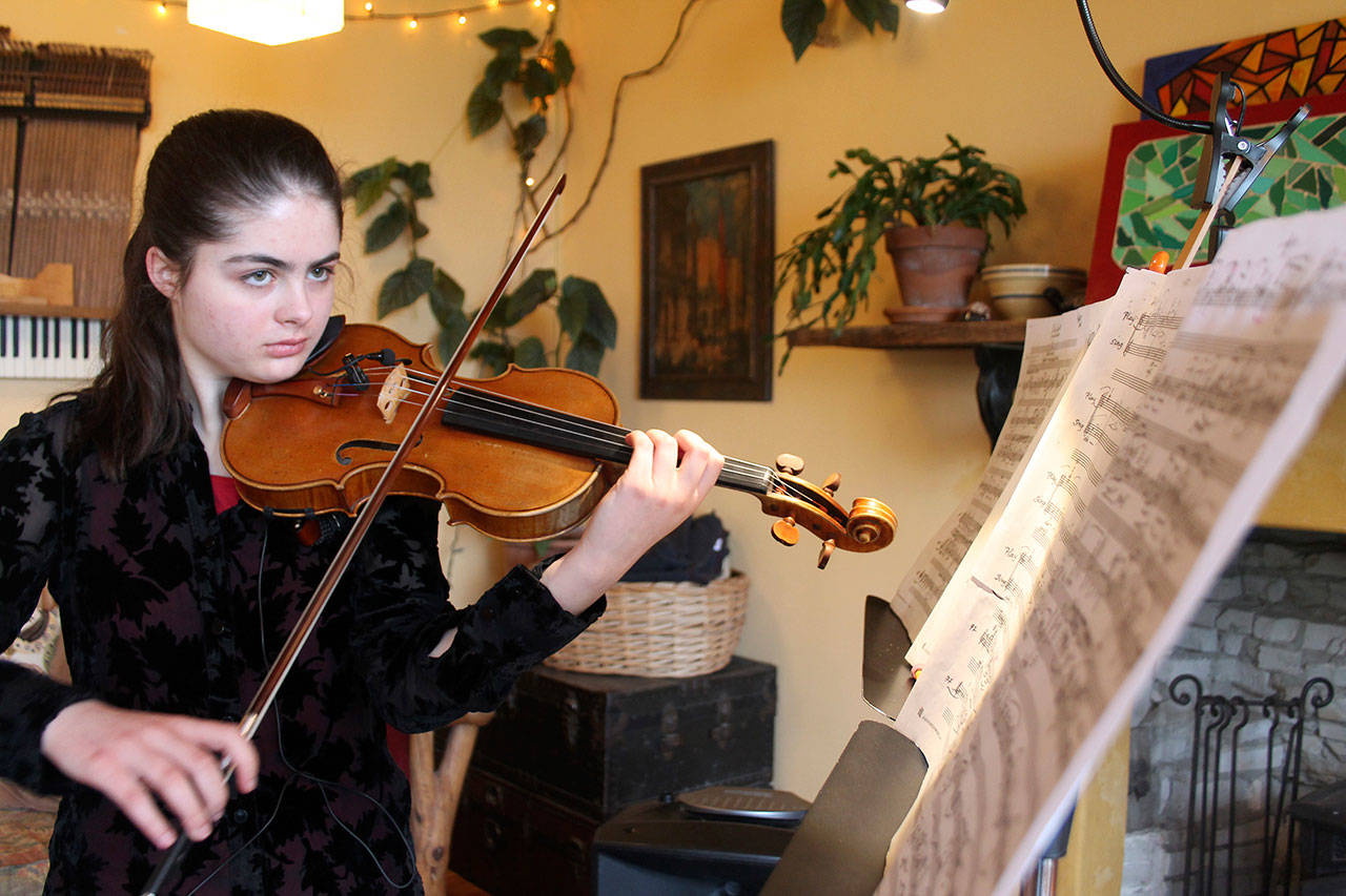 Kyle Jensen / The Record &mdash; Marley Erickson rehearses one of the six cantos written by South Whidbey composer Jerry Mader.