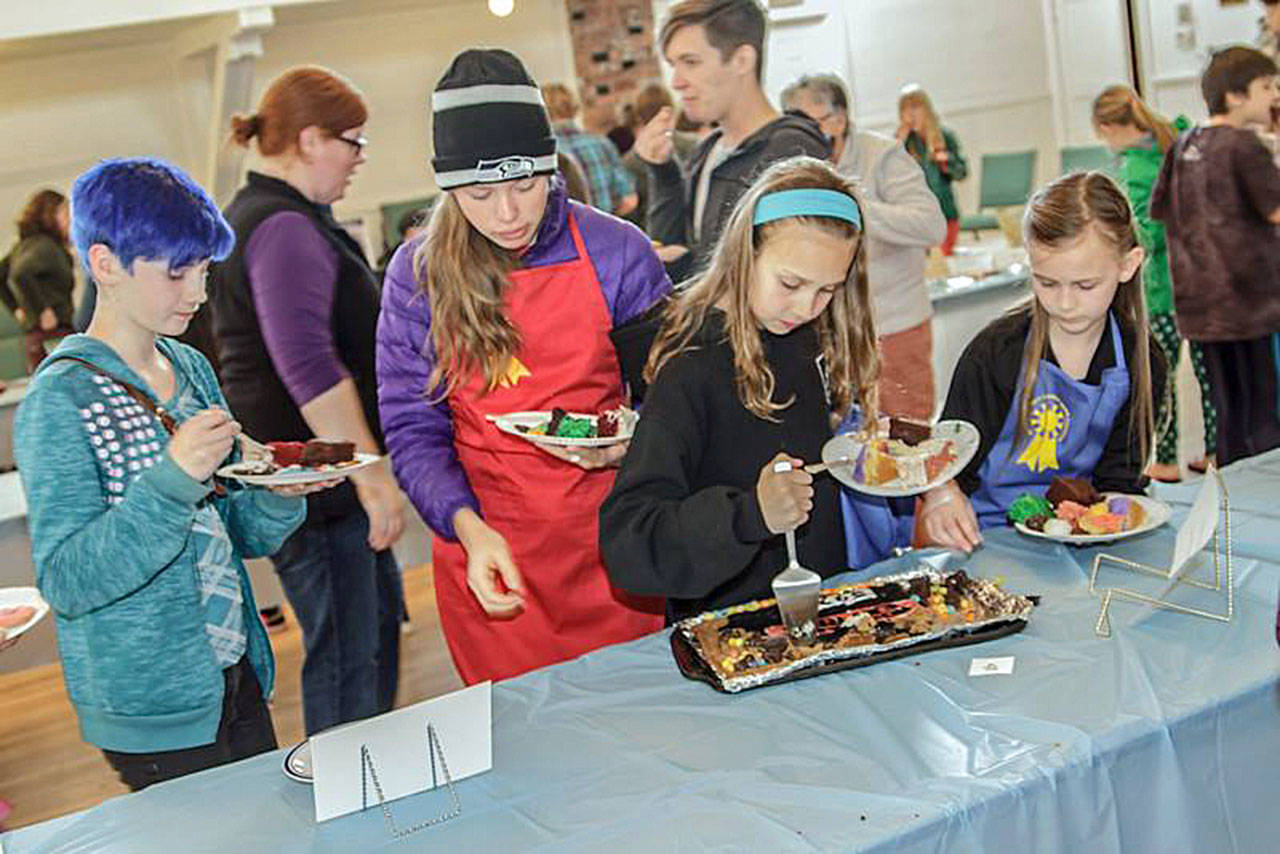 Contributed photo — Participants from the 2016 South Whidbey Edible Book Festival wait their turn to sample one of the entries.