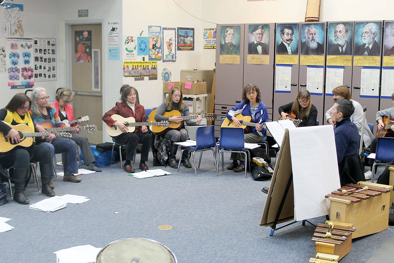 Evan Thompson / The Record — Twenty-three teachers are learning how to play the guitar so that they can integrate music into the learning experience.