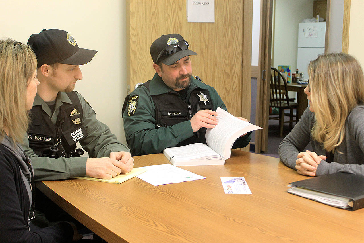 A new outreach team aimed at getting opioid drug addicts into recovery meets recently at Island County Sheriff’s South Whidbey precinct in Freeland. From left to right are Colleen Keefe, public health nurse, deputies Grant Walker and Brent Durley, and outreach team leader Carolyn Pence. Photo by Evan Thompson/South Whidbey Record