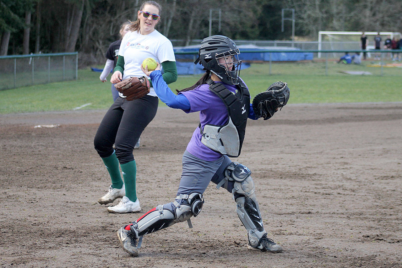 Evan Thompson / The Record — South Whidbey freshman Ari Marshall throws to first base during a practice at South Whidbey High School’s softball field. Marshall will be the Falcons’ starting catcher this season.